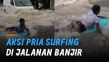 Manfaatkan Momen, Aksi Pria Surfing di Jalanan Banjir