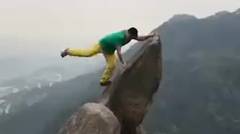 Heart-stopping moment a man fell off cliff edge after posing stunt moves for cliff-top photos