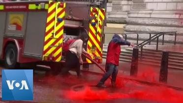 Climate Change Activists Use Fire Engine to Spray Red Paint at UK Treasury