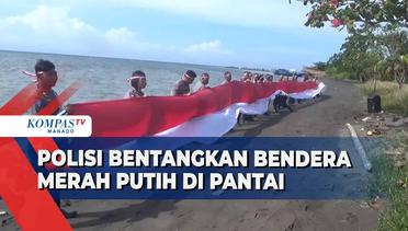Satlantas Bitung Bentangkan Bendera Merah Putih Sepanjang 30 Meter Di Tepi Pantai
