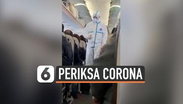 Cegah Corona, Petugas Periksa Penumpang dalam Pesawat